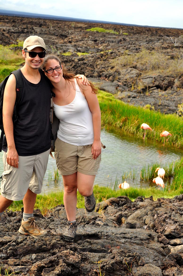 Watching flamingos while standing on lava rocks